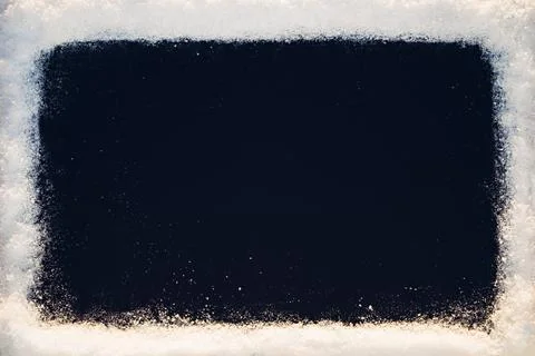 Black background with snow texture frame in sunlight Foto stock