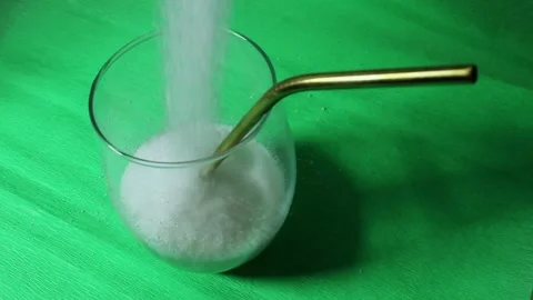 On a black background is sugar labeled “no sugar”. A green apple is rolling Stock Footage 300488741