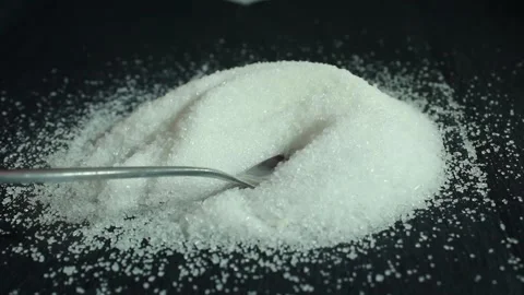 On a black background is sugar labeled “no sugar”. A green apple is rolling Stock Footage 300488744
