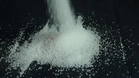 On a black background is sugar labeled “no sugar”. A green apple is rolling Stock Footage 300488775