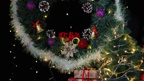 On a black background there are many gifts under a Christmas wreath Stock-Footage 283526160
