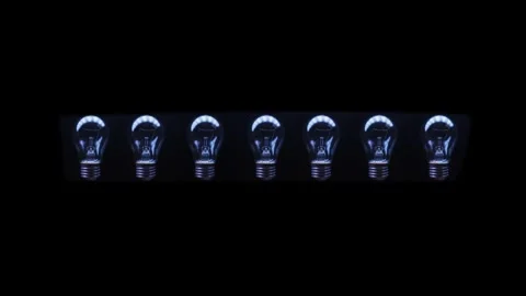 On a black background there is a row of glass electric lamps, one of which is Stock Footage 301756673
