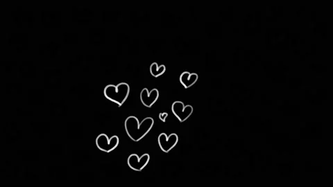 On a black background, white hearts are drawn with chalk. To receive the heart. Stock Footage 146505712