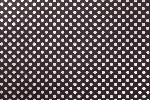Black background from wrapping paper with a pattern of white polka dot closeu Stock Photos