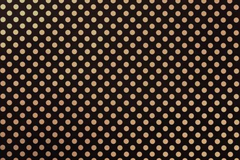 Black background from wrapping paper with a pattern of golden polka dot close Stock Photos