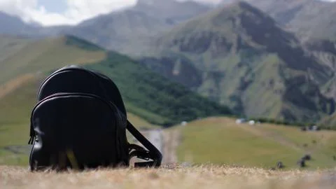 Black backpack on the background of Mount Kazbegi. Traveling in Georgia Stock Photos