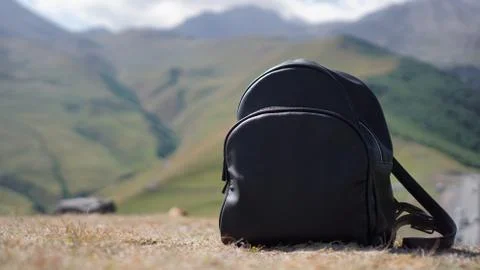 Black backpack on the background of Mount Kazbegi. Traveling in Georgia Stock Photos