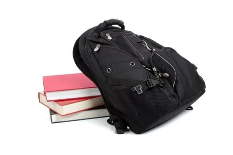 Black backpack with books on white Stock Photos