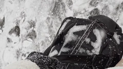 A black backpack covered in snow Stock Footage 274261282
