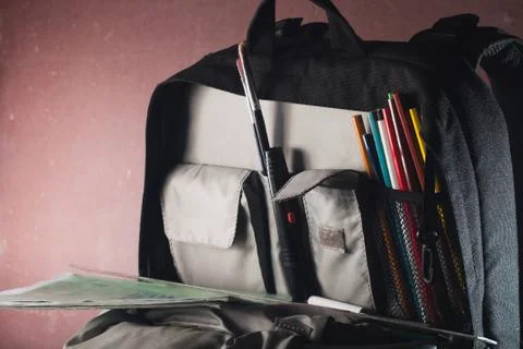 Black backpack with skolkimi items, back to school Stock-Fotos