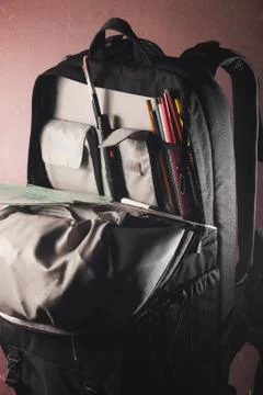 Black backpack with skolkimi items, back to school Foto stock