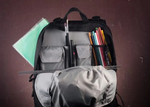 Black backpack with skolkimi items, back to school Stock Photos