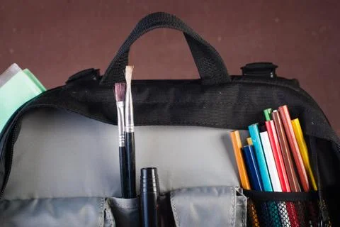 Black backpack with skolkimi items, back to school Stock Photos