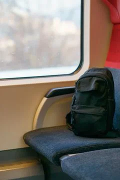 Black Backpack on Train Seat by Window During Calm Passenger Journey Stock Photos