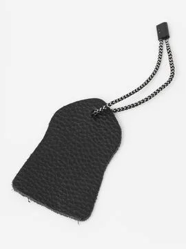 Black bag zipper pull hanging tag Stock Photos