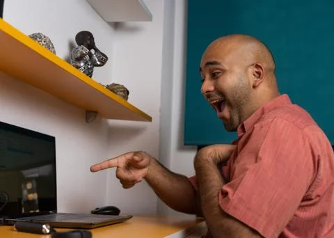 Black bald man pointing at computer Stock Photos