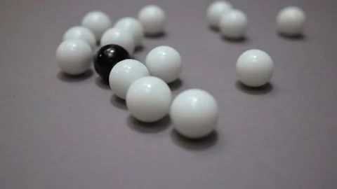 Black ball hits group of white balls on gray surface Stock Footage 147106547