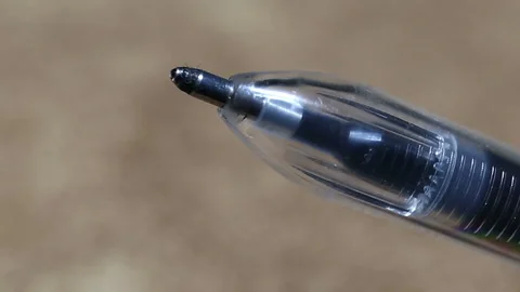 Black ballpoint pen on a beige background extremely close-up, real time. Stock Footage 149218916
