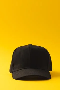 Black baseball cap and copy space on yellow background Stock Illustration
