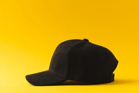 Black baseball cap and copy space on yellow background Stock Illustration
