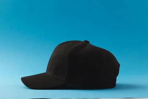 Black baseball cap and copy space on blue background Stock Illustration