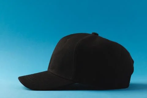 Black baseball cap and copy space on blue background Stock Illustration