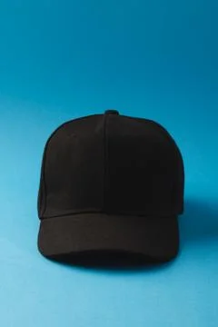 Black baseball cap and copy space on blue background Stock Illustration