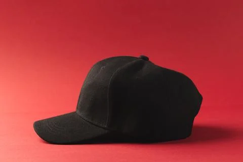 Black baseball cap and copy space on red background 스톡 일러스트