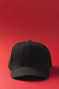 Black baseball cap and copy space on red background Stock Illustration