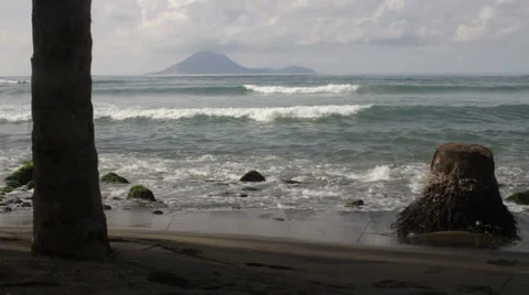 Black beach of St Kitts looking toward island Stock Footage 998893