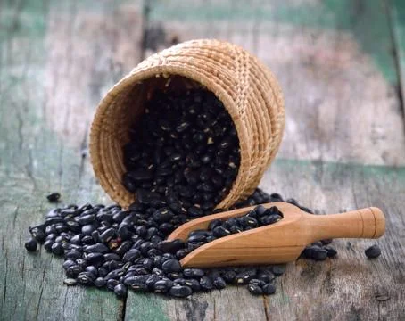Black bean in the spoon on table Stock Photos