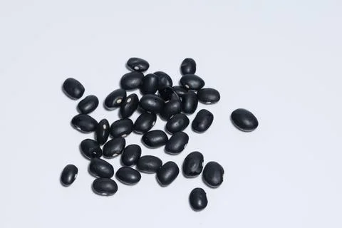 Black beans, white background. Stock Photos