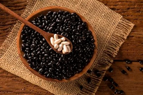 Black beans on wood background Stock Photos