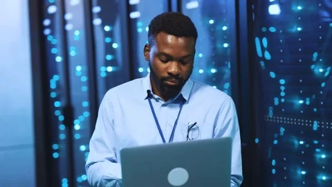 Black bearded IT server engineer working with laptop in cyber security data 库存影片 118450278
