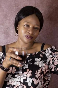 Black Beautiful Woman holds a glass of wine Stock Photos