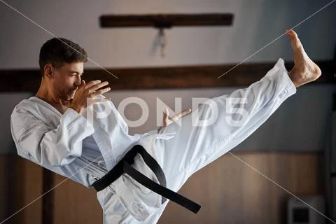 Black belt karate fighter training hight kick Stock Photos