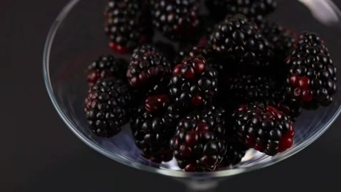 Black berries rotating over gray backdrop, close-up. Macro shot. Market. Stock Footage 327865712