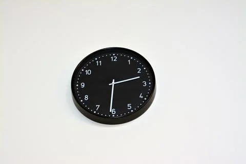 A black big clock hanging at the wall, time concept background, countdown Stock Photos