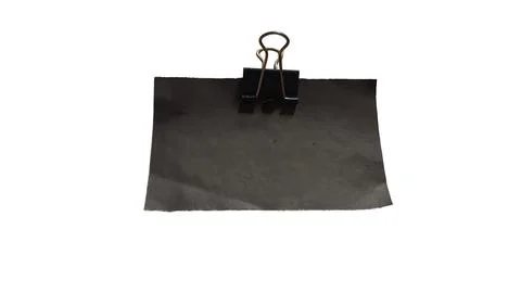 Black binder clip holding gray fabric Stock Illustration