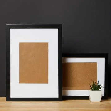 Black blank frames wooden table Stock Photos