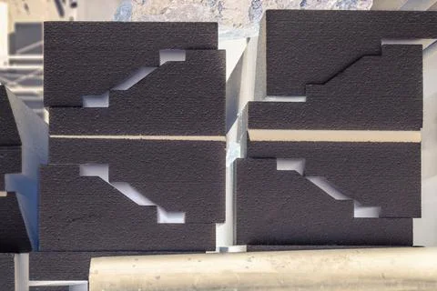 Black blocks of a complex profile lie in stacks Stock Photos
