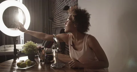 Black blogger checking makeup at start of stream Stock Footage 214954996