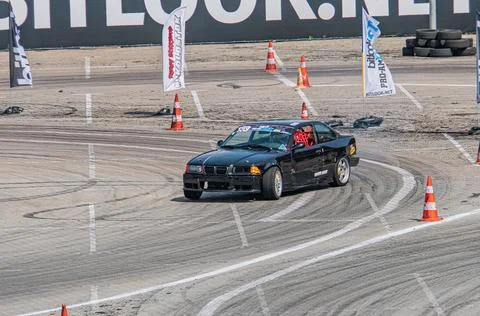 Black BMW drifting on a multi-layered dirt track at Kyiv Car Drifting Festi.. Stock Photos