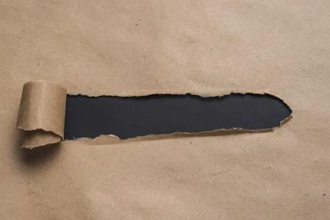 Black board looking through craft paper. High quality photo Stock Photos