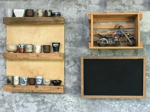 Black board for note hang on wall with ceramic cup and motocycle toy Stock Photos