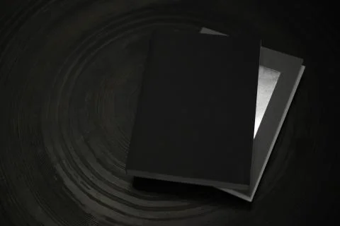 Black book on a black background Stock Photos