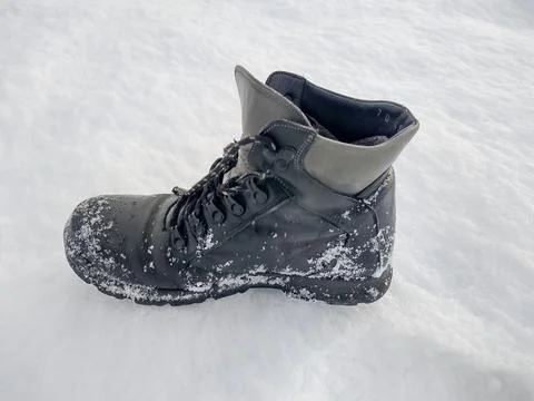 Black boot on snow in the winter Stockfoto's