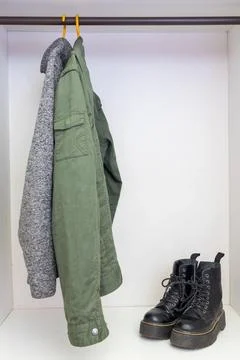 Black boots and a jacket inside Stock Photos