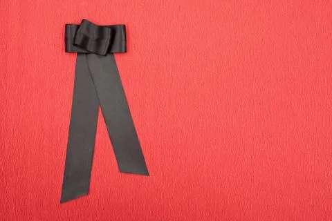 Black bow on red background Stock Photos