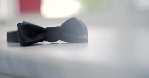 Black bow tie on a bright white surface with soft shallow focus Vídeo Stock 336469422